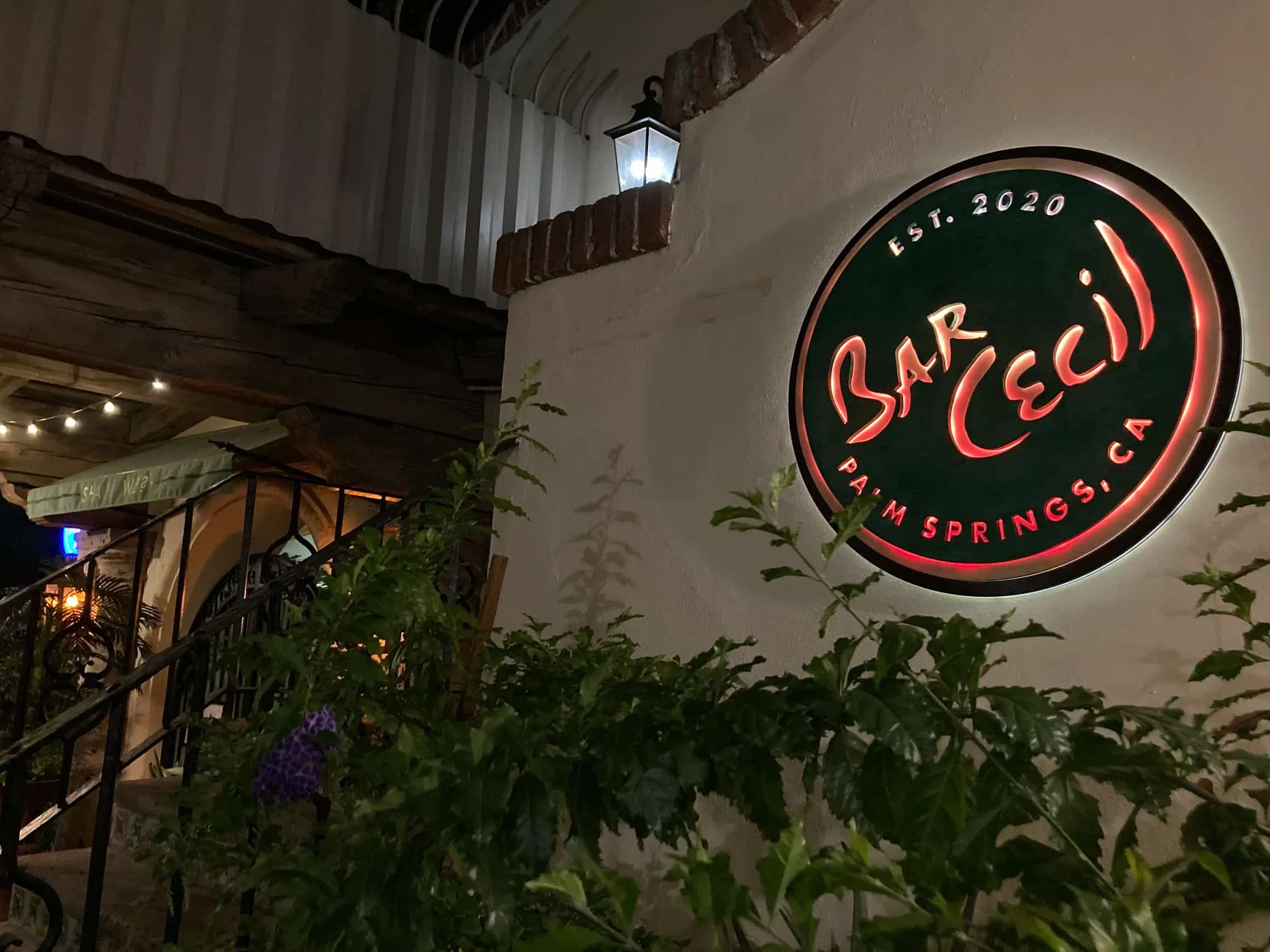 YoreBoard-designed and manufactured LED sign for Bar Cecil, a restaurant in Palm Springs. The vibrant, backlit circular sign displays the establishment's name and founding year, showcasing YoreBoard's custom signage capabilities at night.