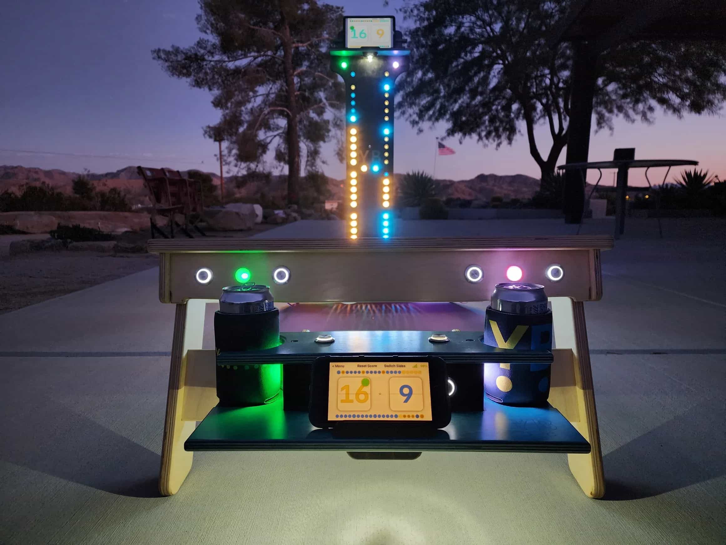 Connected YoreBoard cornhole set showcasing bright multi-colored Scoring LEDs on the board, digital scoreboard on an attached scorebox, and a vertical score tower with synchronized digital scoring and LEDs.