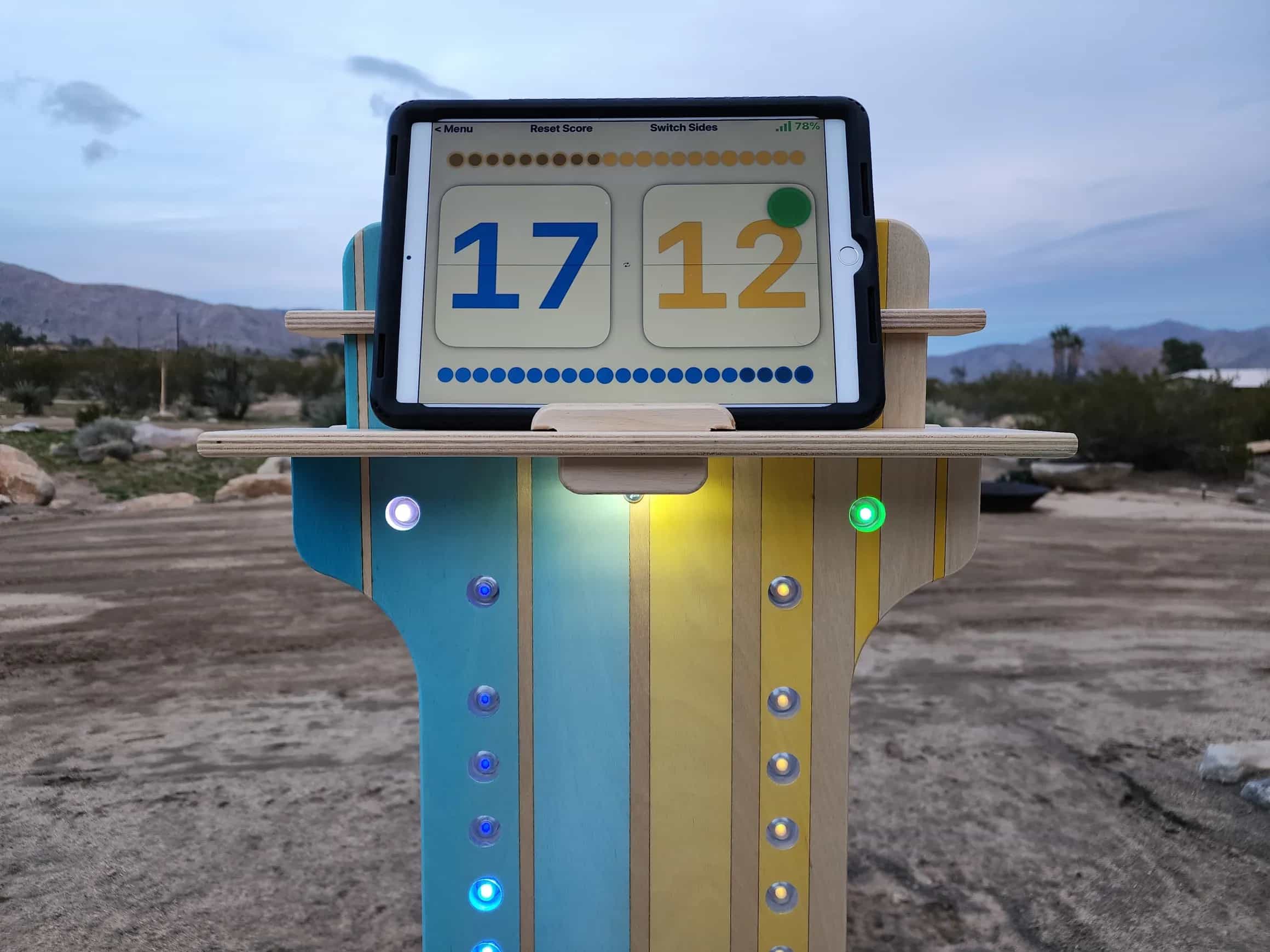 YoreBoard score tower demonstrating real-time visual scoring with a tablet showing 17-12, precisely mirrored by the number of lit blue and yellow Scoring LEDs on its vertical display.